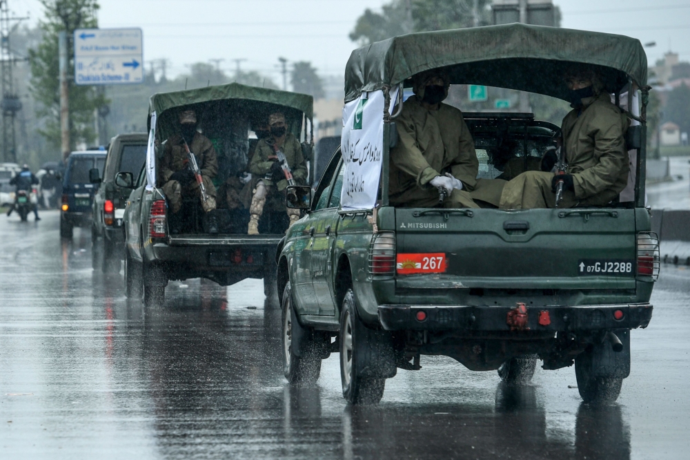 File: Army personnel patrol on a road in Rawalpindi / AFP 