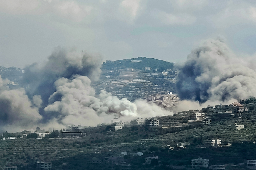 Smoke billows from the site of an Israeli air strike in the Lebanese village of Jibal el Botm, near the Lebanon-Israel border, on September 23, 2024. (Photo by Kawnat Haju/ AFP)