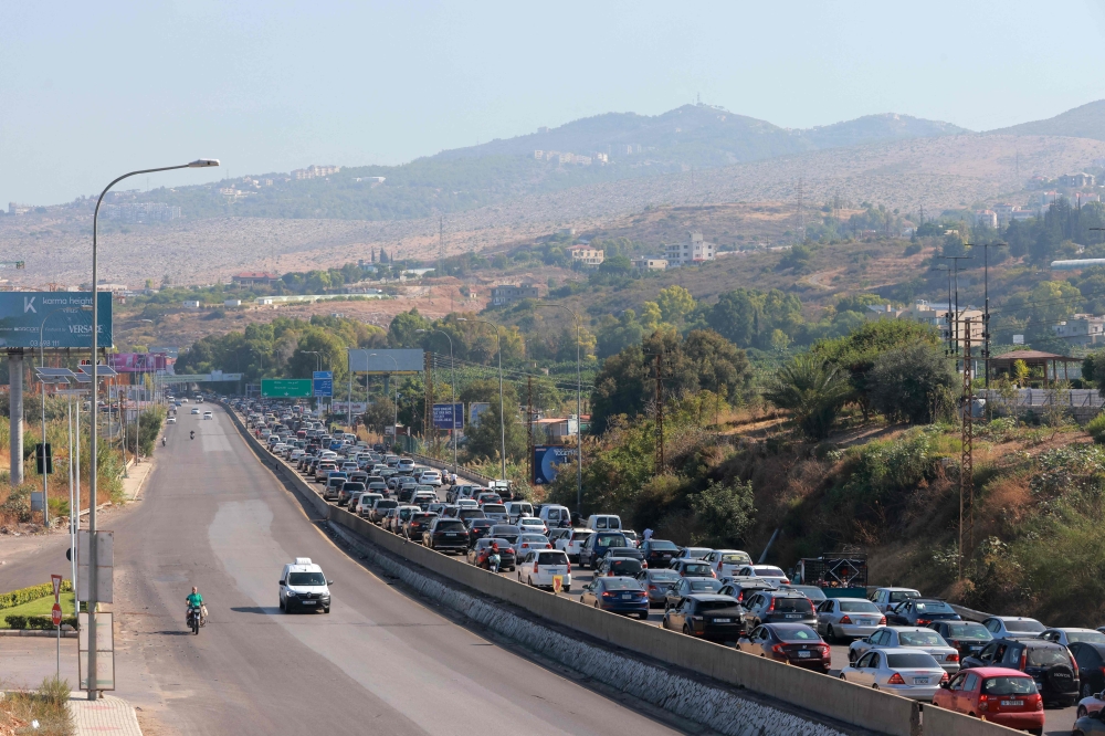 Vehicles wait in traffic in the town of Damour, south of the capital Beirut on September 24, 2024, as people flee southern Lebanon. (Photo by Ibrahim Amro / AFP)