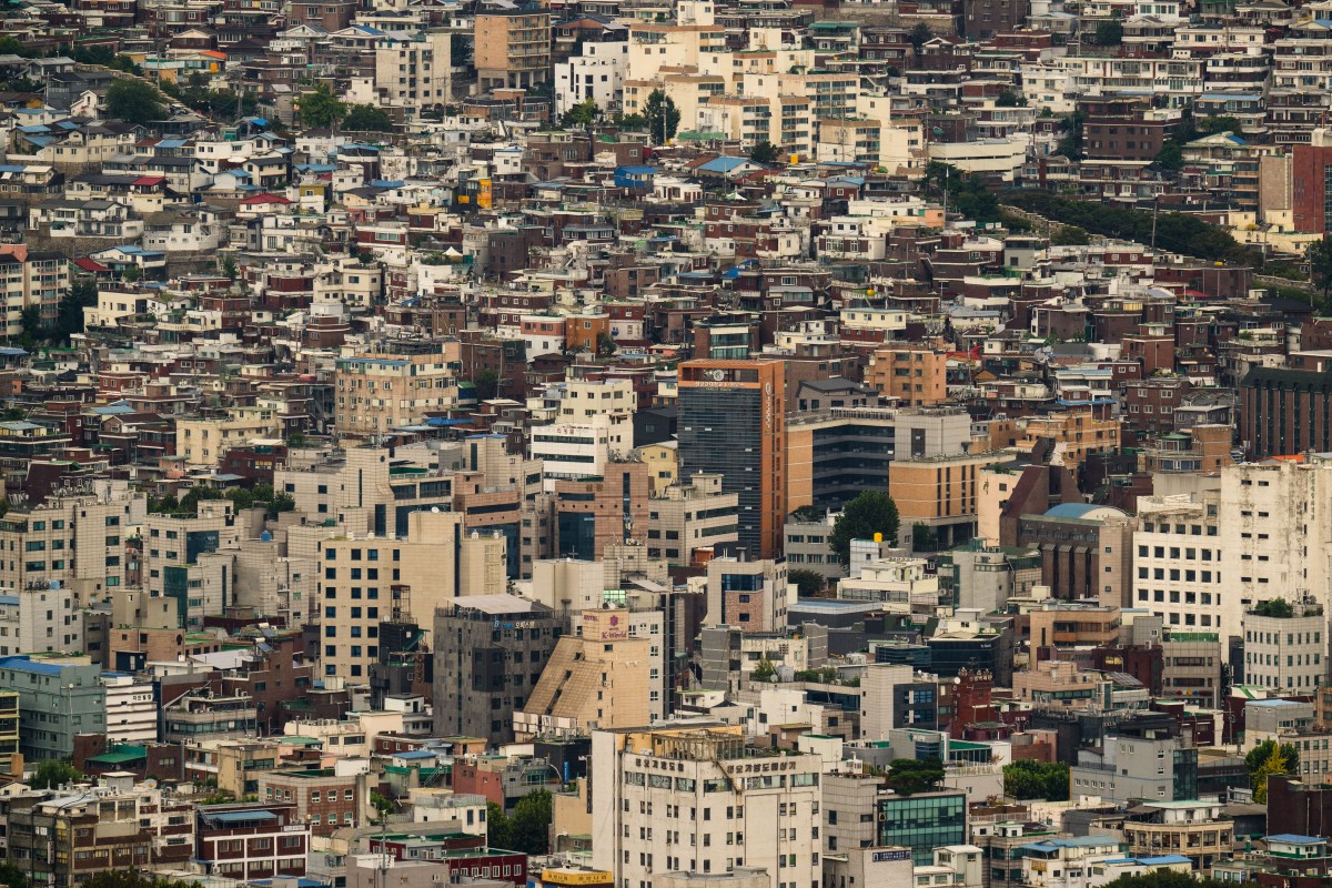 A general view taken below the Namsan Tower shows commercial and residential buildings in Seoul on September 25, 2024. (Photo by ANTHONY WALLACE / AFP)
