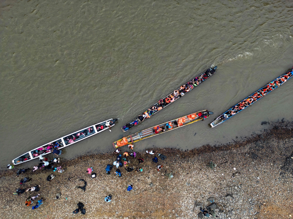 This aerial view shows migrants on arrival at the Temporary Reception Centre for Migrants in Lajas Blancas, in the jungle province of Darien, 250 km east of Panama City, Panama, on September 26, 2024. (Photo by Martin Bernetti / AFP)