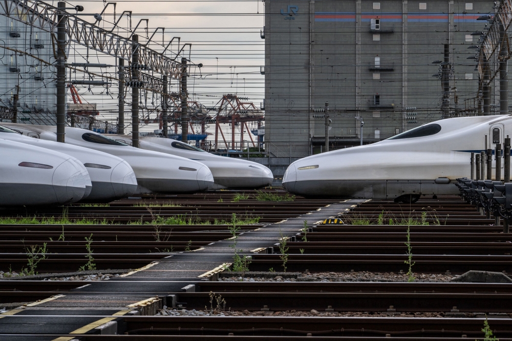 This general view taken on July 24, 2024 shows N700A and N700S series trains parked at the JR Central's Shinkansen depot in the Shinagawa district of Tokyo. (Photo by Philip Fong/ AFP) 