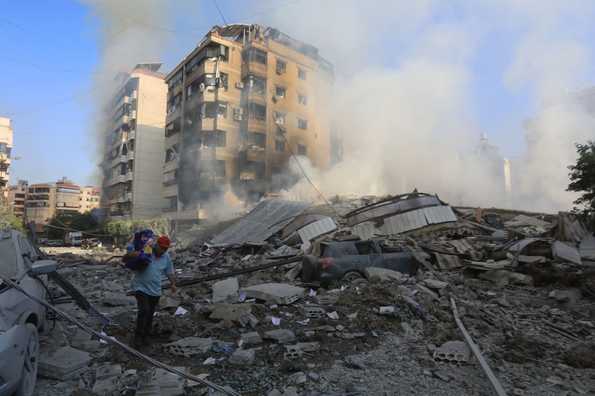 A man walks through the rubble as people check on September 28, 2024 the devastation in the Hadath neighbourhood of Beirut's southern suburbs in the aftermath of overnight Israeli airstrikes on the outskirts of the Lebanese capital. (Photo by AFP)
