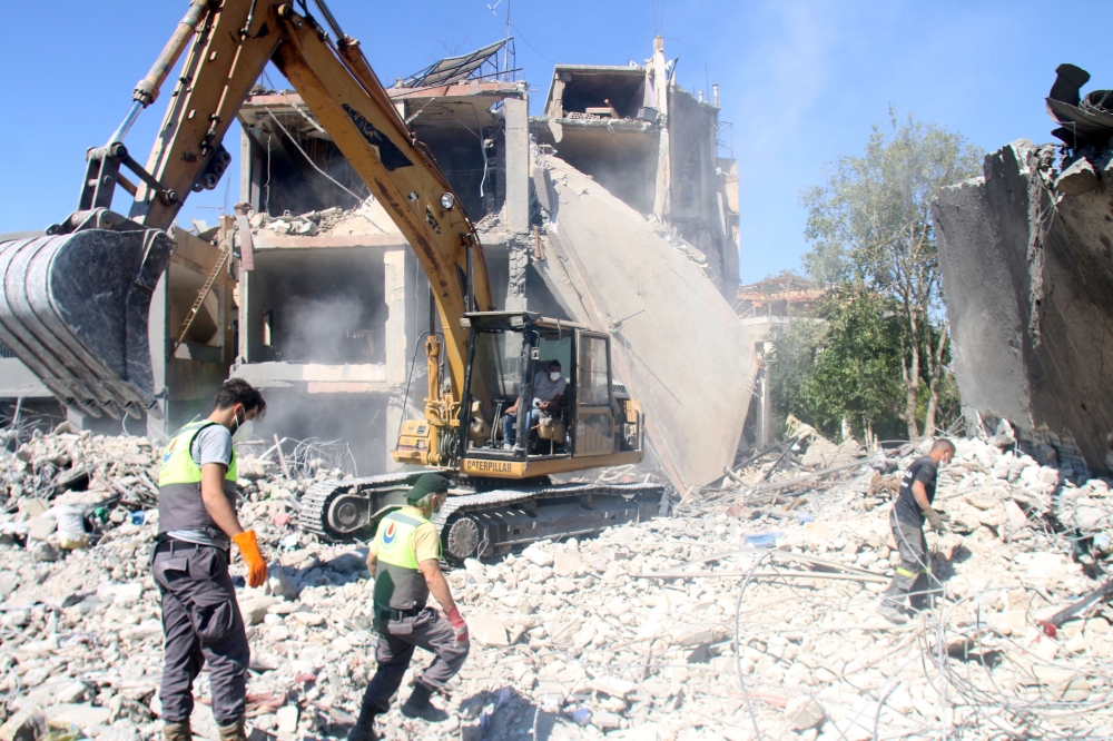 Civil defence workers dig through the rubble of a building at the site of an overnight Israeli airstrike that targeted a neighbourhood in the eastern city of Baalbek on September 30, 2024. (Photo by AFP)
