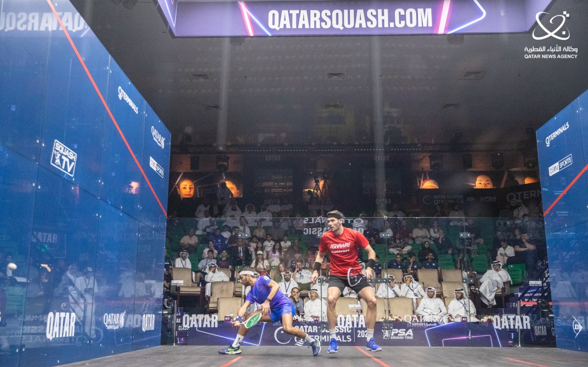 Qatar's Abdulla Al Tamimi (left) in action against England's Adrian Waller during their Q-Terminals Qatar Classic match, yesterday.