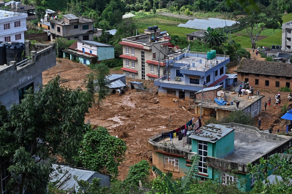 A general view of a landslide-affected village is pictured following heavy rains in Lalitpur district on the outskirts of Kathmandu on October 1, 2024. (Photo by Prakash Mathema / AFP)