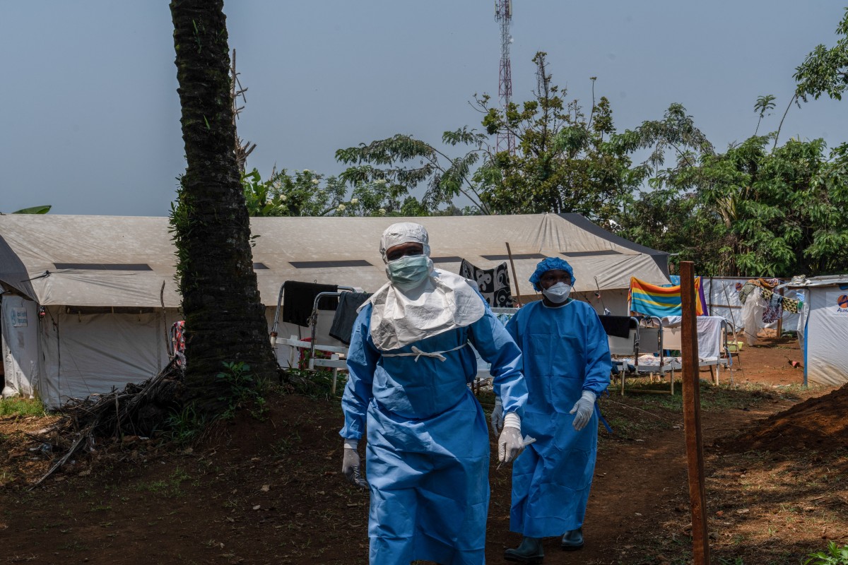 Two workers from the NGO Alima walk in the courtyard of the mpox treatment centre in Kamituga, South Kivu in the east of the Democratic Republic of Congo on September 20, 2024. Photo by Glody MURHABAZI / AFP.