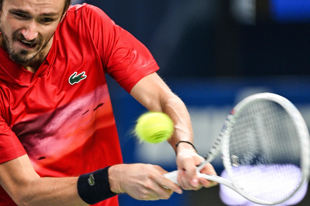 Russia's Daniil Medvedev hits a return to Italy's Matteo Arnaldi during their men's singles match at the Shanghai Masters tennis tournament in Shanghai on October 6, 2024. (Photo by Hector RETAMAL / AFP)
