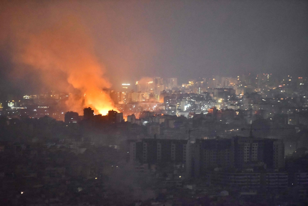 Flames and smoke rise in an area targeted by an Israeli air strike on Beirut's southern suburbs, October 6, 2024. (Photo by Fadel Itani / AFP)