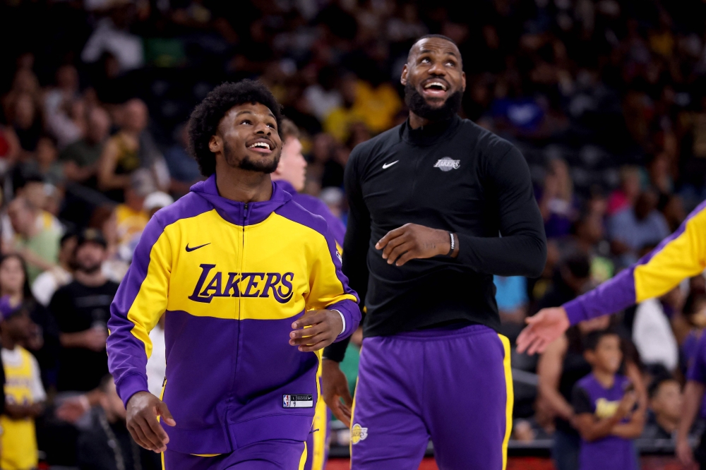 Bronny James #9 and LeBron James #23 of the Los Angeles Lakers warm up prior to the game against the Phoenix Suns on October 06, 2024 in Palm Springs, California. Katelyn Mulcahy/Getty Images/AFP 