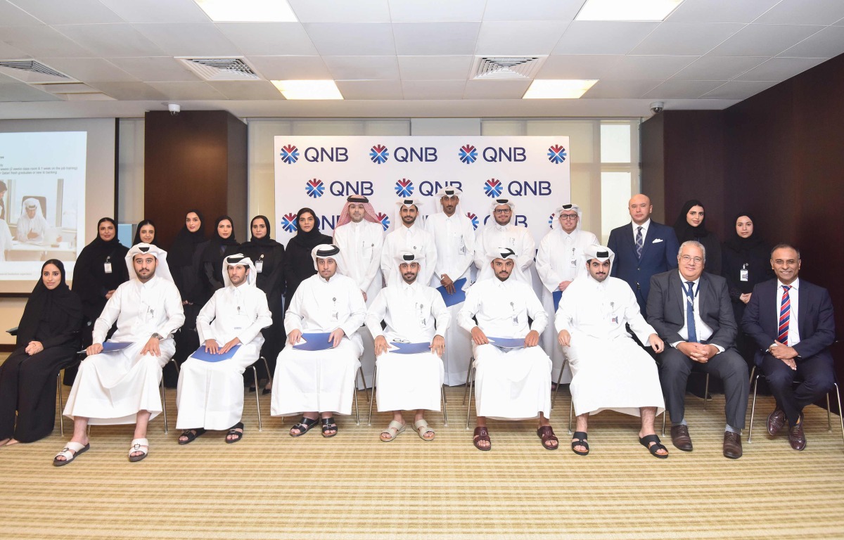 QNB officials along with Qatari graduates during the Induction program.