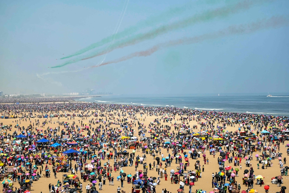 Surya Kiran Aerobatics Team of the Indian Air Force (IAF) perform an airshow during celebrations ahead of the Indian Air Force day at Marina beach in Chennai on October 6, 2024. All pictures by R.Satish Babu / AFP