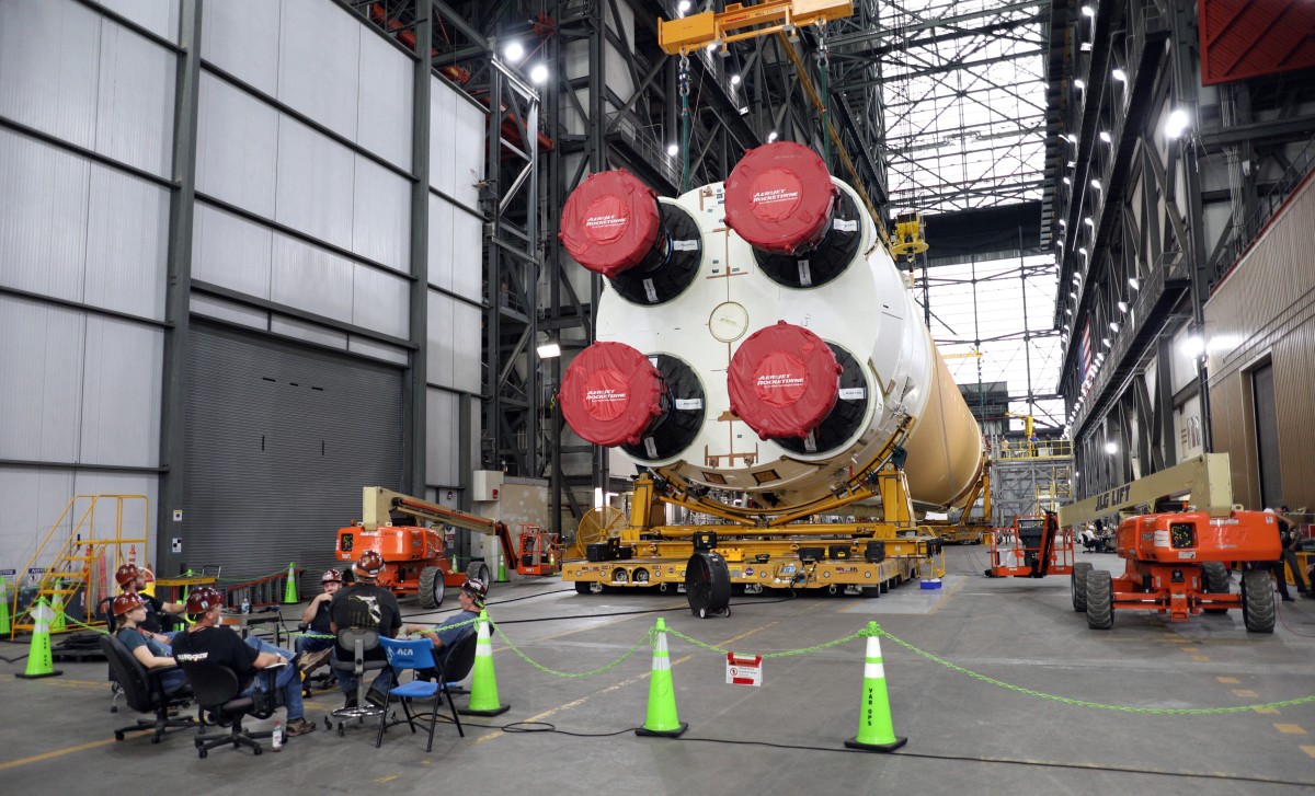 Workers take a break inside the Vehicle Assembly Building next to the Artemis II core stage of NASA's Space Launch System at the Kennedy Space Center in Florida on September 28, 2024. Photo by Gregg Newton / AFP.