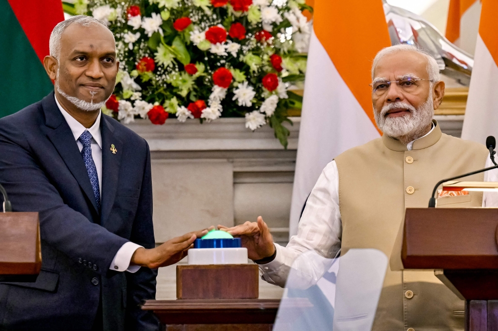 India's Prime Minister Narendra Modi (right) and Maldives President Mohamed Muizzu virtually inaugurate the new runway at Maldives' Hanimadhoo International Airport, during a joint media briefing at the Hyderabad House in New Delhi on October 7, 2024. (Photo by Money Sharma / AFP)