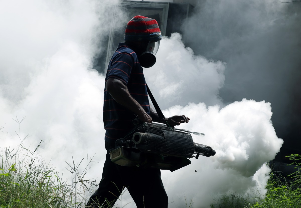 File: A worker sprays insecticide to prevent mosquito breeding at a railway station in Colombo, Sri Lanka, May 13, 2023. (Photo by Ajith Perera/Xinhua)