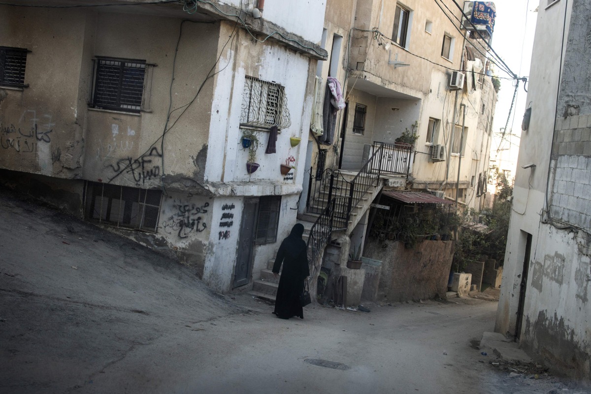 A Palestinian woman walks through the Jenin refugee camp on October 9, 2024 , in the Israeli occupied West Bank. (Photo by JOHN WESSELS / AFP)
