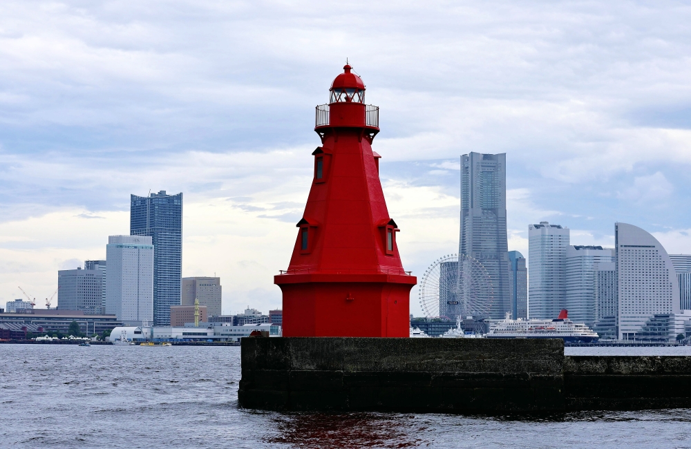 The Yokohama Kita Suitei Lighthouse, a century old and still a working lighthouse, is seen against the city skyline. (Photo by The Japan News)