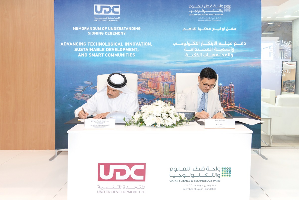 UDC President, CEO, and Member of the Board, Ibrahim Jassim Al Othman, and the President of QSTP, Dr. Jack Lau during the agreement signing.