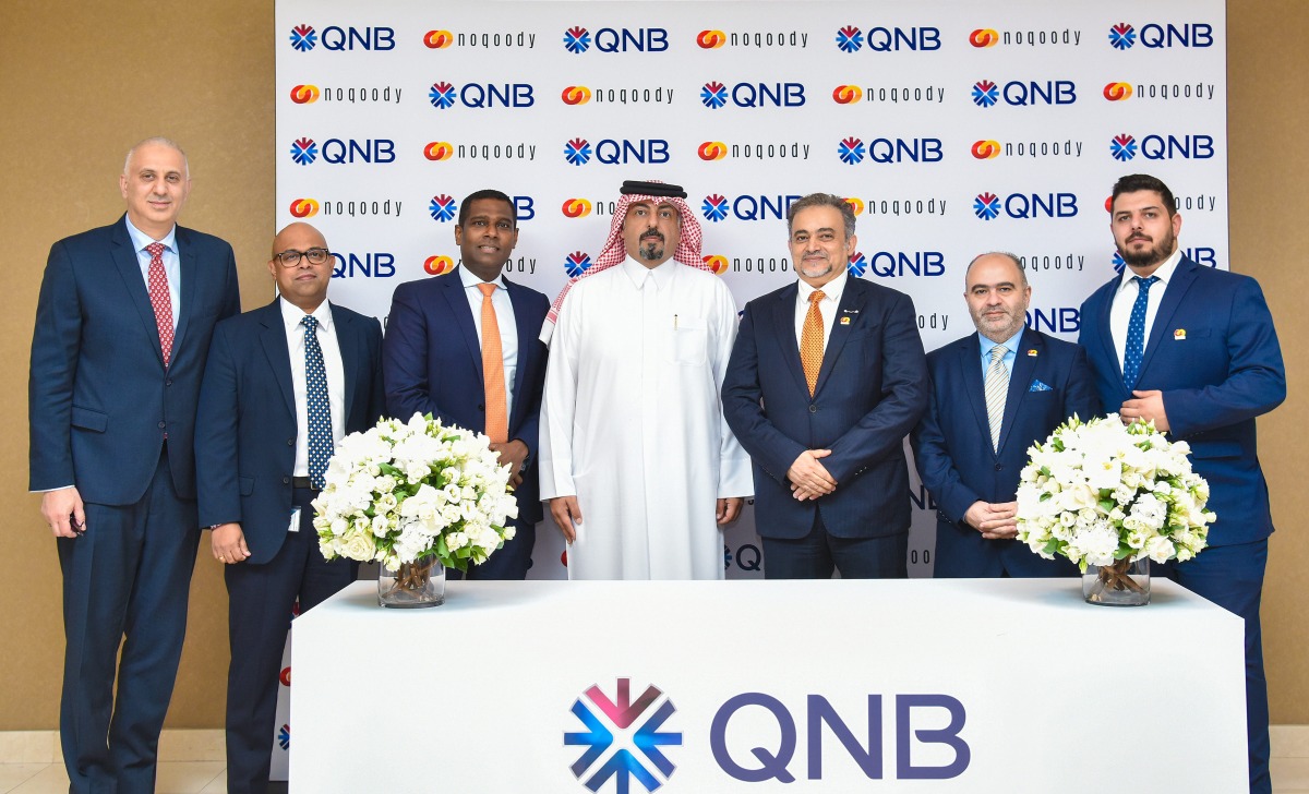 Senior Executive Vice President, QNB Group Retail Banking Adel Ali Al Malki; CEO of Noqoody Payment Services, Nayef Rashvan with other officials pose for a group photo.