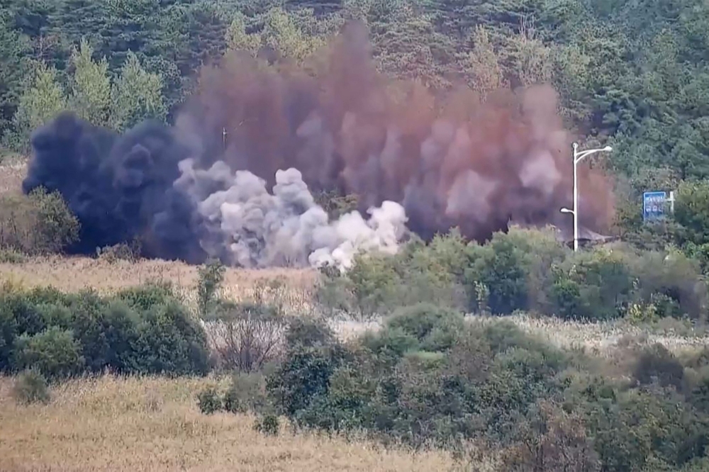 This screen grab taken from video released by the South Korean Defence Ministry and filmed from an undisclosed location in South Korea along the inter-Korean border shows an explosion on a road connecting North and South Korea on October 15, 2024. Photo by Handout / South Korea Defense Ministry / AFP