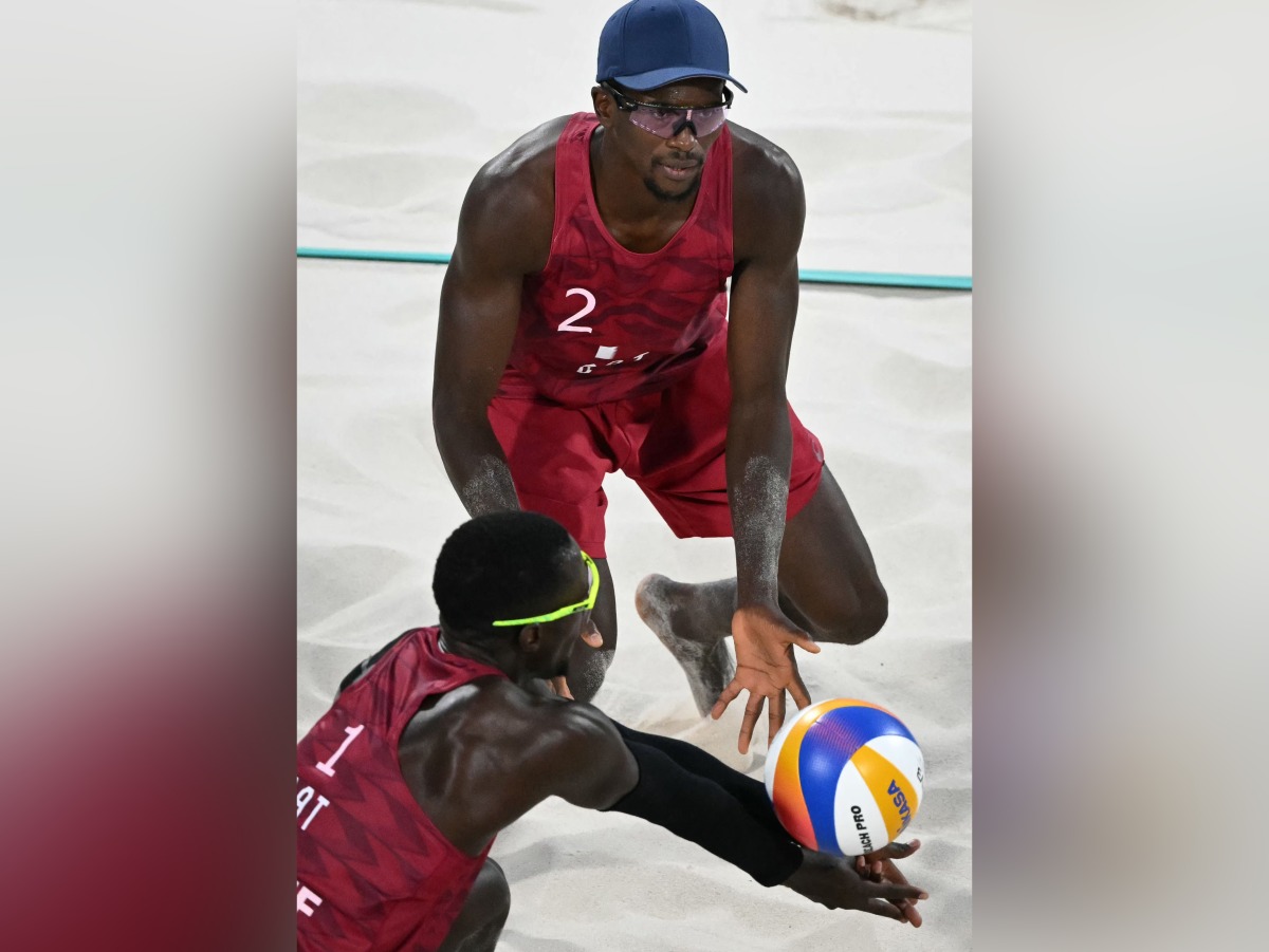 Qatar’s Cherif Younousse (down) and Ahmed Tijan in action, in this file photo.