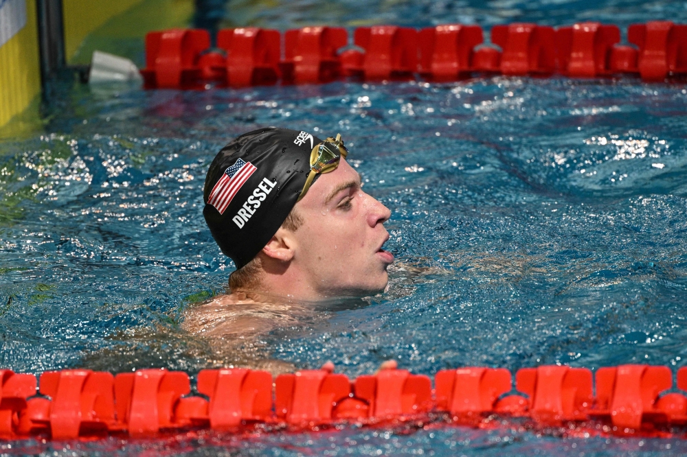 France's Leon Marchand reacts after competing in the men 100m medley event during the World Aquatics Swimming World Cup 2024 - Stop 1 at the Oriental Sports Centre Natatorium in Shanghai, on October 18, 2024. (Photo by Hector RETAMAL / AFP)