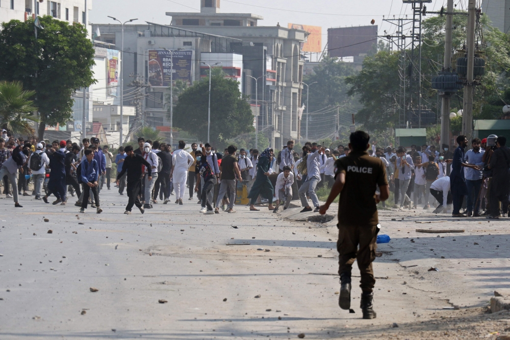 Students hurl stones towards security personnel during a demonstration to condemn the alleged rape of a female student in Rawalpindi on October 17, 2024. (Photo by Ghulam Rasool / AFP)