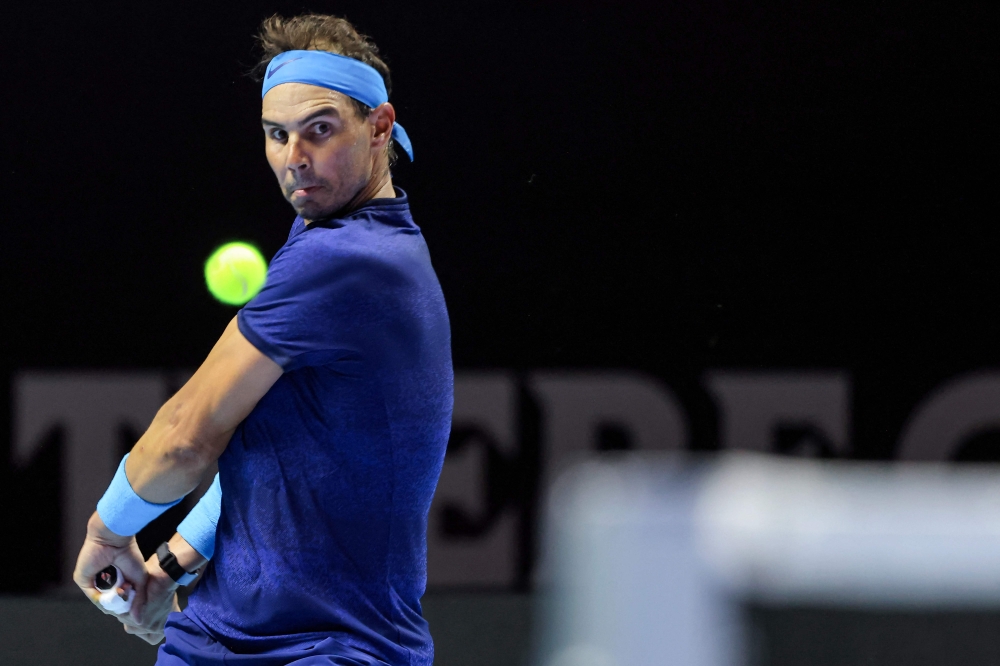 Spain's Rafael Nadal hits a return to Serbia's Novak Djokovic during their third-place tennis match in the 