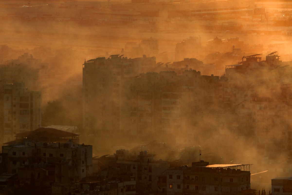 Smoke fumes cover a neighborhood of Beirut's southern suburbs near one of the runways of Beirut International Airport following an Israeli airstrike on on October 19, 2024. Photo by AFP.
