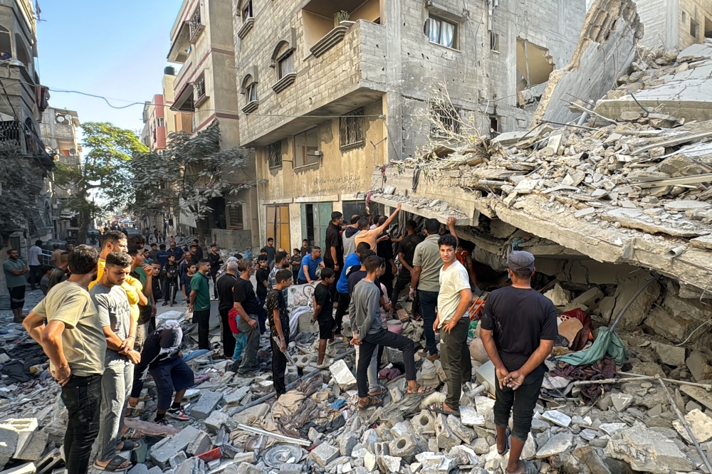 Palestinians inspect the damage after an Israeli airstrike in Beit Lahia, in the northern Gaza Strip on October 19, 2024. (Photo by Islam Ahmed / AFP)