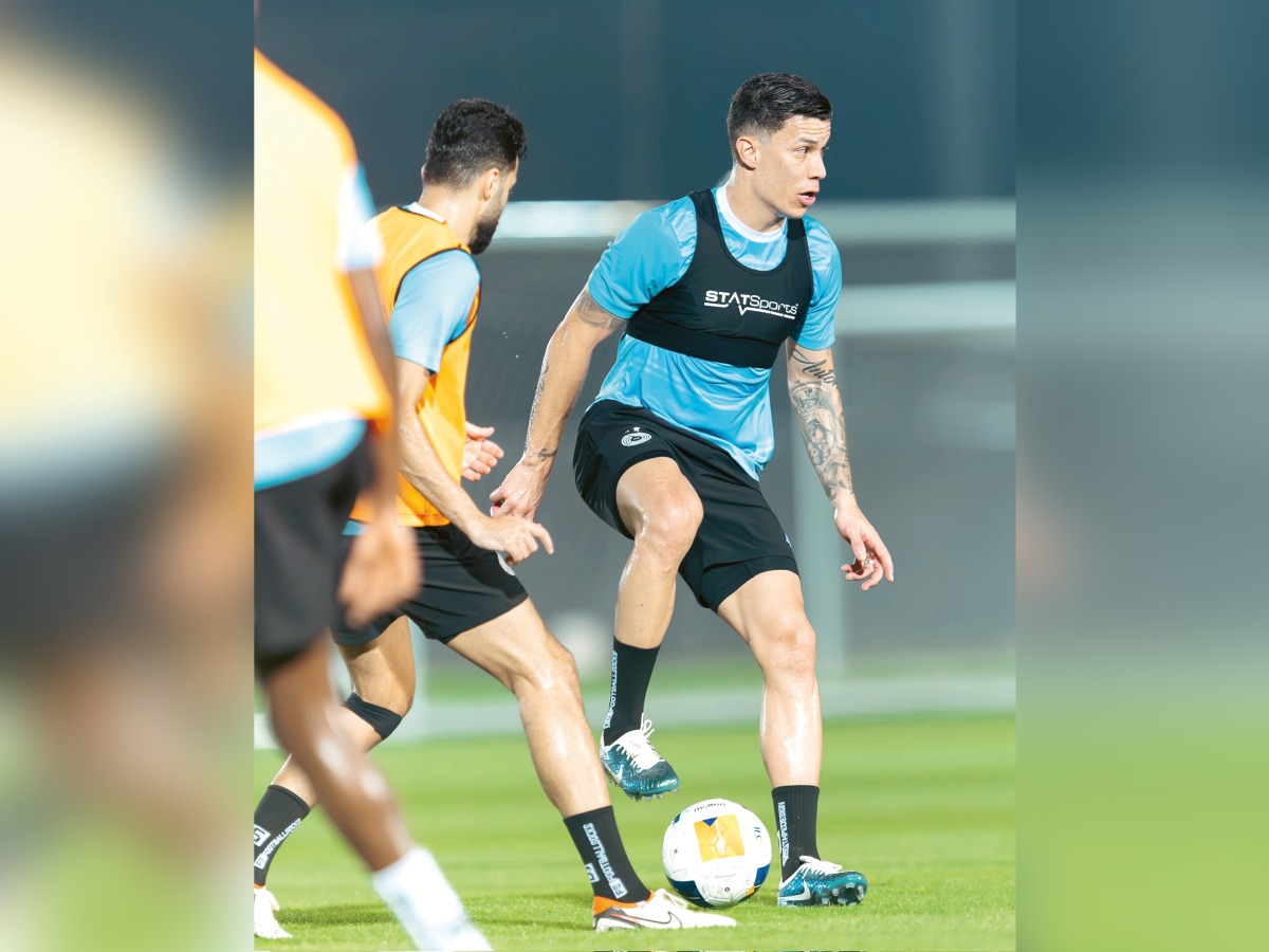 Al Sadd's Colombian midfielder Mateus Uribe (right) with a teammate during a training session.