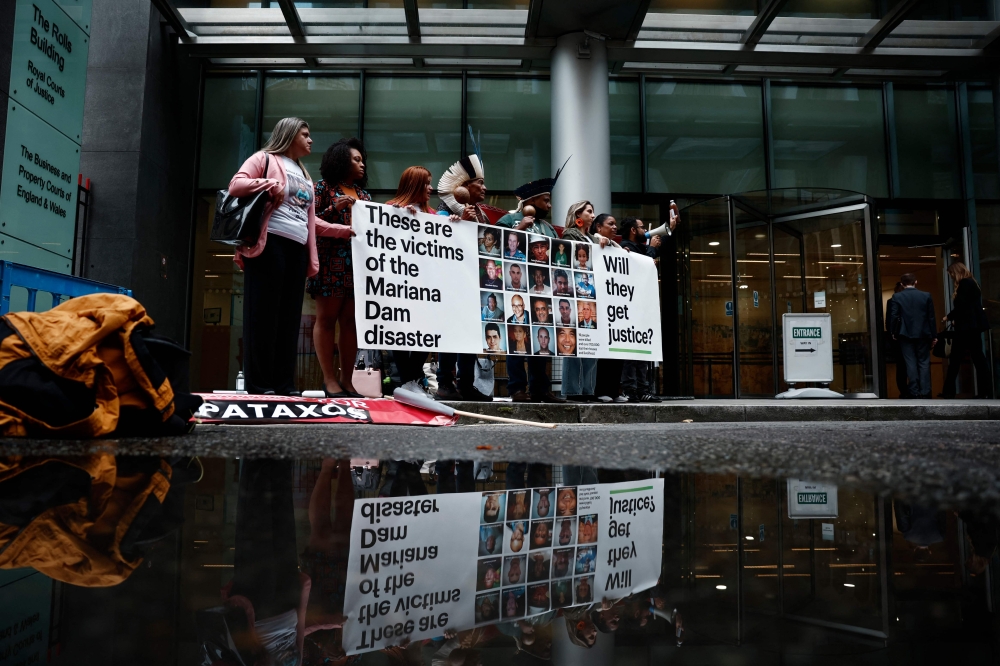 Victims and relatives of victims of the dam rupture gather outside the Rolls building of the High court of Justice in London, on October 21, 2024, on the opening day of the trial of the mining company BHP's responsibilities over 2015 toxic Brazil mine disaster. Photo by BENJAMIN CREMEL / AFP