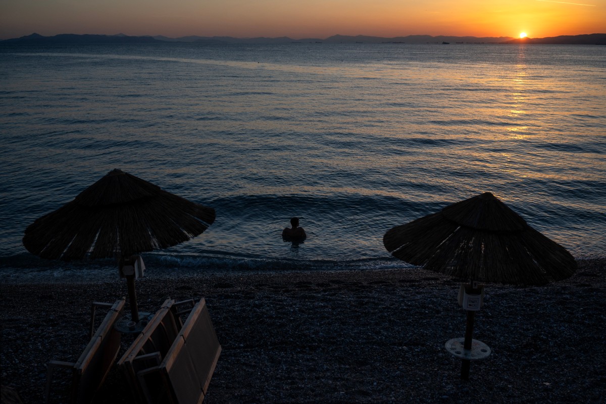 A man swims at Alimos beach in Athens on October 15, 2024. (Photo by Angelos TZORTZINIS / AFP)
