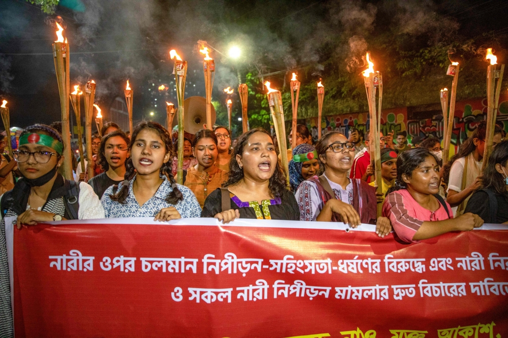 Female students chant slogans during a protest to condemn violence against women in Dhaka on October 22, 2024. (Photo by Salahuddin Ahmed / AFP)