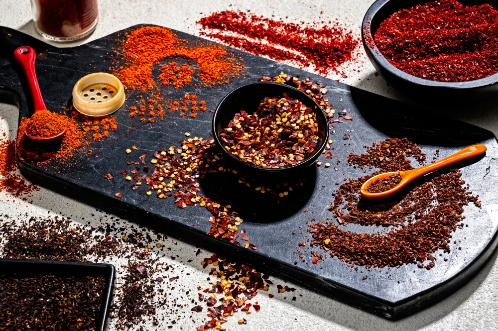 (Clockwise from top left) Chile flakes: Piment d’Espelette, Gochugaru, Aleppo, Crushed red pepper flakes and Urfa biber. Photo by Scott Suchman for The Washington Post; food styling by Lisa Cherkasky for The Washington Post