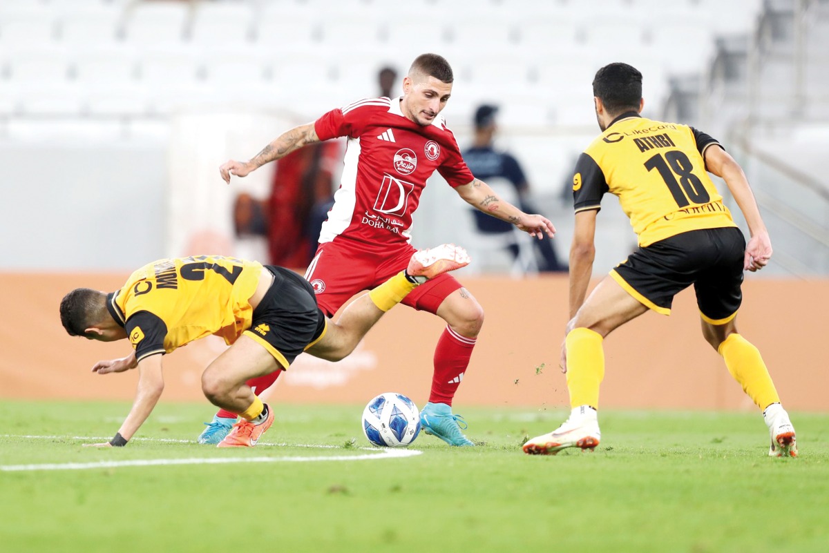 Al Arabi's Marco Verratti (centre) vies for the ball possession with two Al Qadsia players during yesterday's match. 