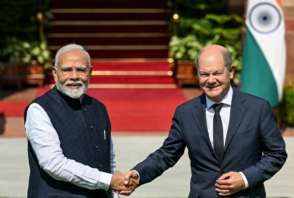 India's Prime Minister Narendra Modi (L) shakes hands with German Chancellor Olaf Scholz before their meeting at the Hyderabad House in New Delhi on October 25, 2024. (Photo by Money SHARMA / AFP)