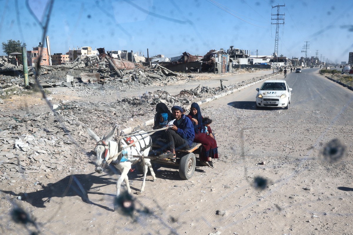 Photo used for demonstration purposes. People are seen through the shrapnel-riddled windscreen of a bus that was damaged when an Israeli artillery shell reportedly landed near it on Gaza's main Salah al-Din road outside Deir el-Balah in the central Gaza Strip on October 24, 2024. Photo by Eyad BABA / AFP.
