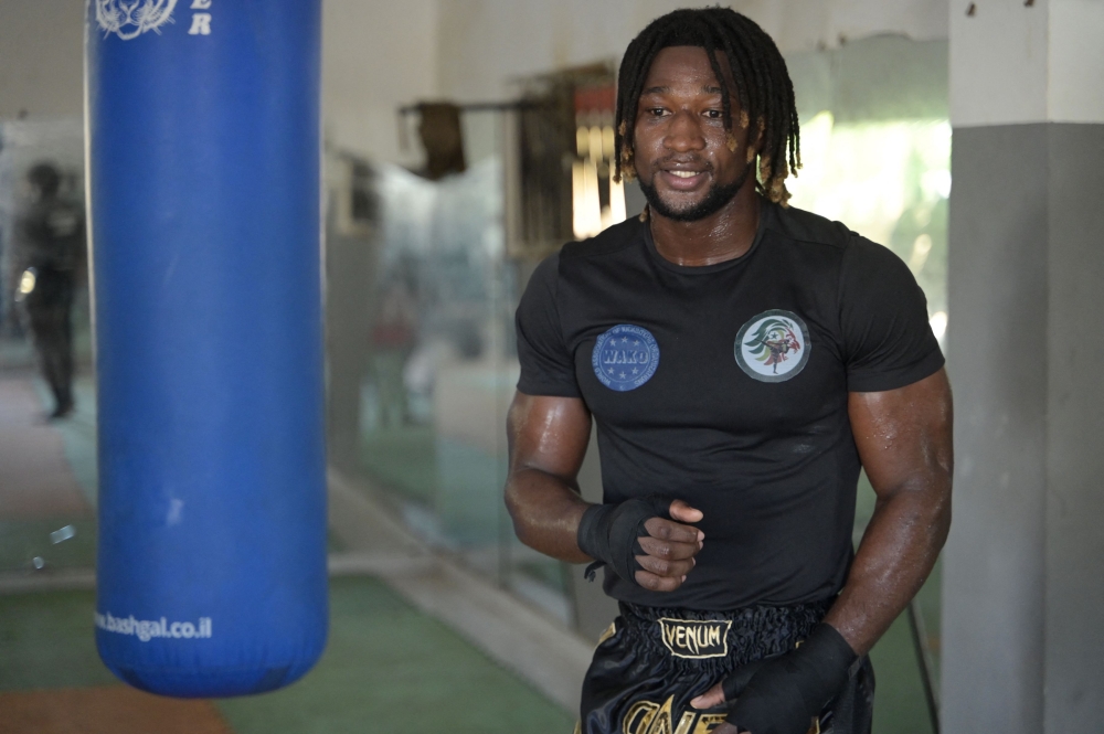 World Kickboxing Champion Mouhamed Tafsir Ba pauses during a training session at the sports hall of the Abdou Diass police camp on October 13, 2024. (Photo by Seyllou / AFP)