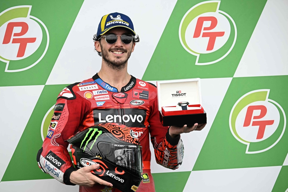 Ducati Lenovo Team's Italian rider Francesco Bagnaia celebrates coming in pole position in the qualifying session of the MotoGP Thailand Grand Prix at the Buriram International Circuit in Buriram on October 26, 2024. (Photo by Lillian SUWANRUMPHA / AFP)