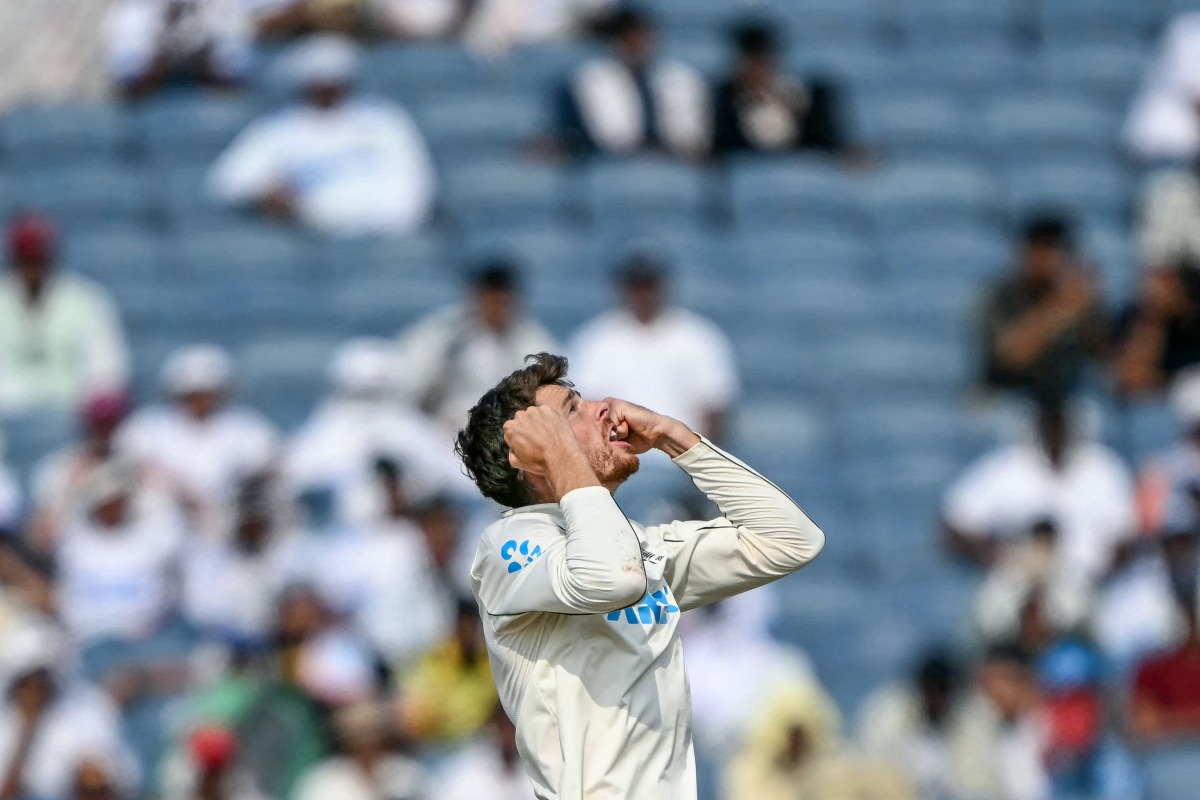 New Zealand's Mitchell Santner celebrates after taking the wicket of India's Ravichandran Ashwin during the third day of the second Test cricket match between India and New Zealand at the Maharashtra Cricket Association Stadium in Pune on October 26, 2024. (Photo by Punit PARANJPE / AFP)