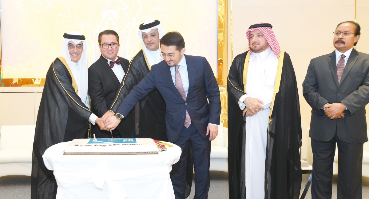 Minister of Communications and Information Technology H E Mohammed bin Ali Al Mannai (third left); Minister of State and President of Qatar National Library H E Hamad bin Abdulaziz Al Kawari (first left); Kazakh Minister of Digital Development, Innovations and Aerospace Industry H E Zhaslan Madiyev (third right); and Ambassador of Kazakhstan H E Arman Issagaliyev (second left) cutting the cake to mark the occasion, while H E Ambassador Ibrahim Yousif Abdullah Fakhro (second right), Director of the Protocol Department at Ministry of Foreign Affairs; and Dean of Diplomatic Corps, and Ambassador of Eritrea H E Ali Ibrahim Ahmed look on.