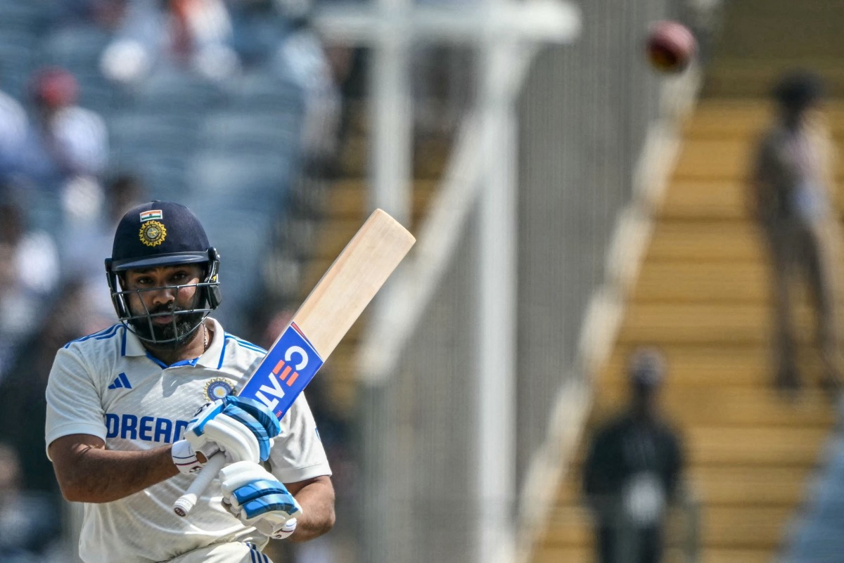 India's captain Rohit Sharma watches the ball after playing a shot during the third day of the second Test cricket match between India and New Zealand at the Maharashtra Cricket Association Stadium in Pune on October 26, 2024. (Photo by Punit PARANJPE / AFP)