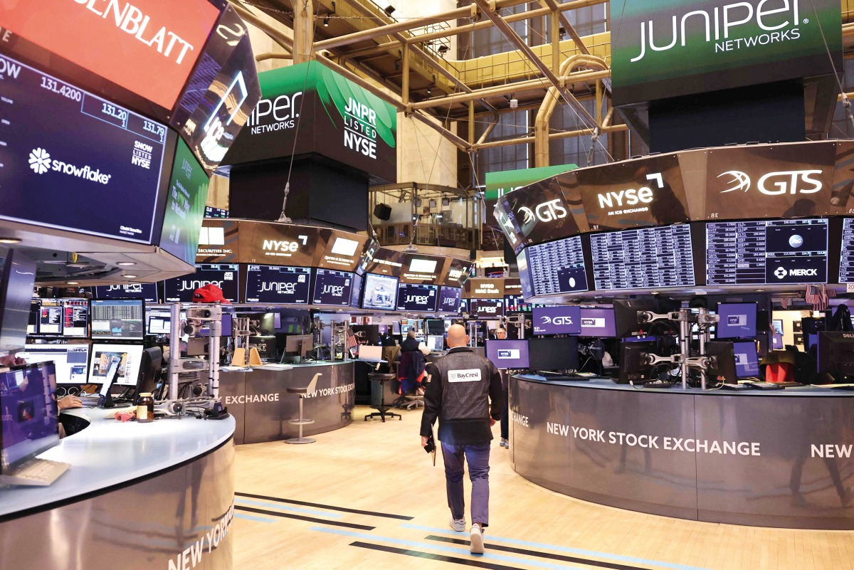 A file photo of traders working on the floor of the New York Stock Exchange during morning trading in New York City, US. (AFP)