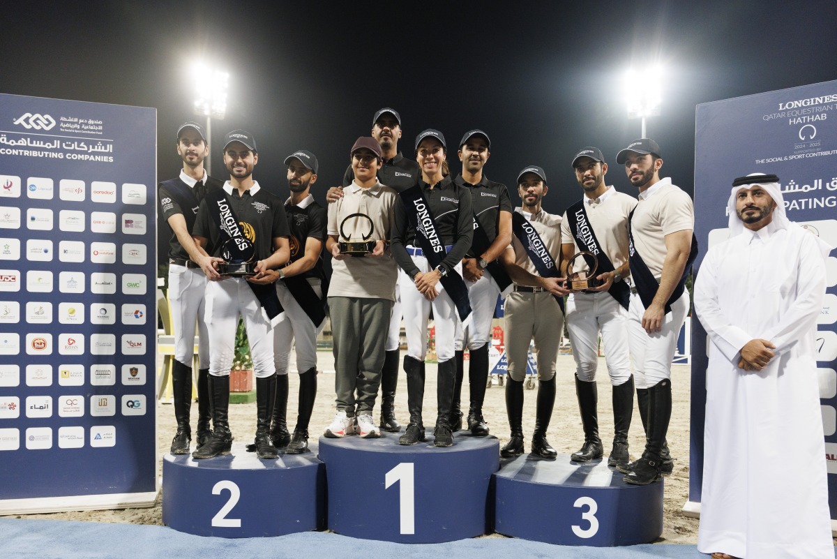 Members of top three finishing teams in  Medium Tour Team category pose on the podium with QEF Assistant Secretary Ali bin Yousef Al Rumaihi.