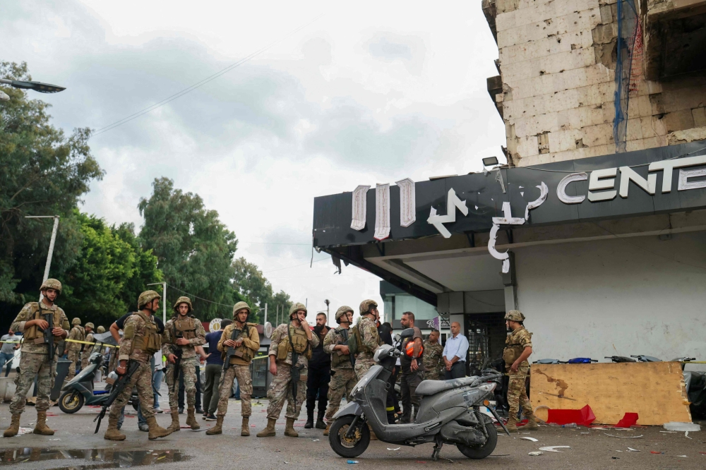 Lebanese army soldiers secure the area outside a building that was targeted in an Israeli airstrike in Beirut's southern suburbs on November 2, 2024. (Photo by Ibrahim Amro / AFP)