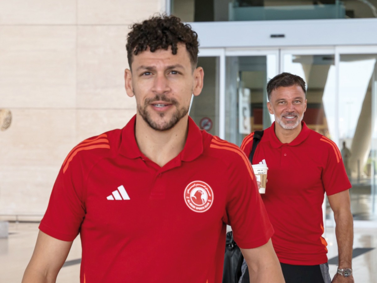 Al Arabi's Youssef Msakni (left) and coach Anthony Hudson arrive in Manama.