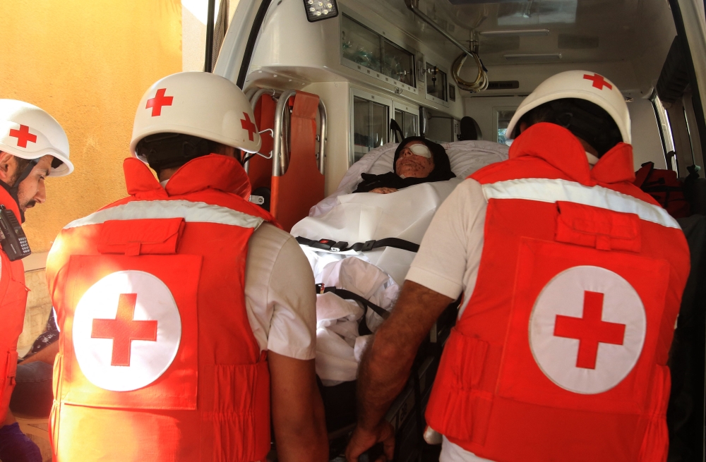 Lebanese Red Cross volunteers transport injured 32-year-old Zainab Khalifeh from the Alaa Addin hospital in the southern town of Sarafand, to be transferred by ambulance to a specialised medical institution in Beirut for the continuation of her treatment, on November 5, 2024. (Photo by Mahmoud Zayyat / AFP)