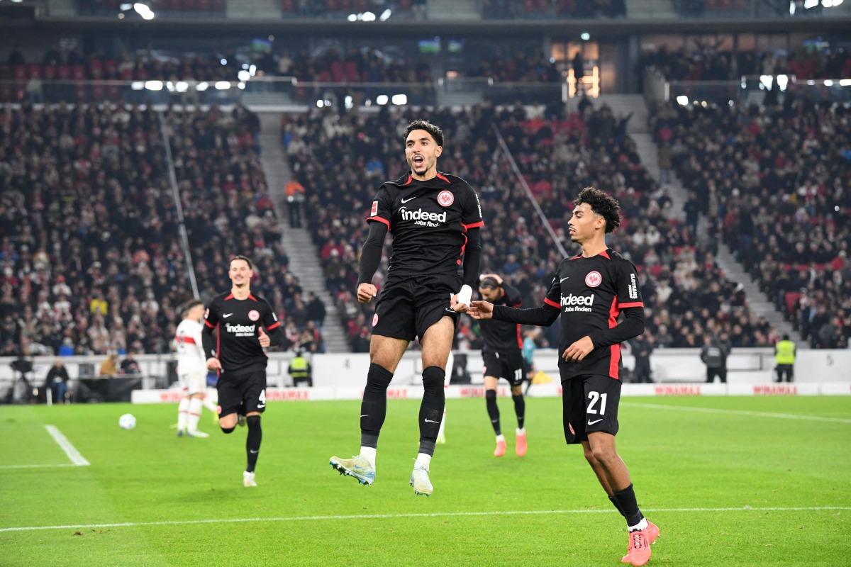 Frankfurt's Egyptian forward #07 Omar Marmoush (C) celebrates with Stuttgart's German defender #07 Maximilian Mittelstaedt (R) after scoring the 0-3 goal during the German first division Bundesliga football match VfB Stuttgart vs Eintracht Frankfurt in Stuttgart, southwestern Germany on November 10, 2024. (Photo by Thomas KIENZLE / AFP)