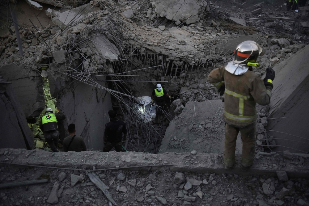 Rescue teams looks for survivors at the site of an Israeli airstrike that targeted a house where displaced people lived in the village of Baalshmay in the Lebanese mountains, east of Beirut, on November 12, 2024. (Photo by Fadel Itani / AFP)